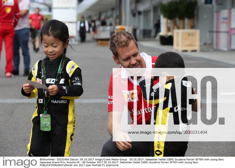 Sebastian Vettel (GER) Scuderia Ferrari SF70H with young fans Japanese Grand Prix, Suzuka 05 - 08 October 2017 05.10.2017- Sebastian Vettel (GER) Scuderia Ferrari SF70H with young fans