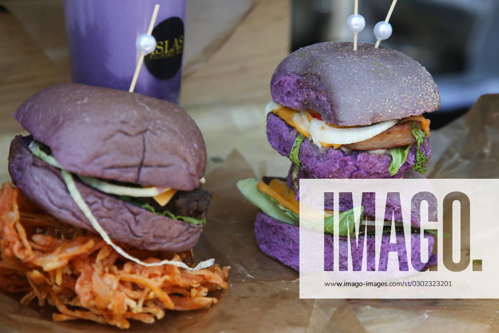 Ube Bun Burgers Ube bun burgers displayed at a food stall during the Taste of Manila Food Festival in Toronto, Ontario, Canada, on August 20, 2023. The festival took place in the area is also popularly known as Little Manila, and is the largest Filipino food festival in Toronto. Authentic Filipino cuisine is the biggest highlight of the festival, offering thousands of attendees a chance to try lumpia, halo halo, lechon, pancit, and other traditional food delights. Toronto Ontario Canada