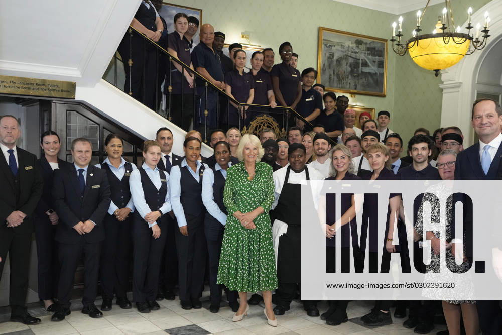 Britain s Queen Camilla poses for a photograph with members of staff at the Royal Air Force Club in London, Tuesday, Aug. 29, 2023. Her Majesty The Queen unveiled a portrait of SOE Operative, Noor-un-Nisa Inayat Khan GC, and formally announced the name of a room in her honour at the Royal Air Force Club., Credit:Kirsty Wigglesworth Avalon GBR, London