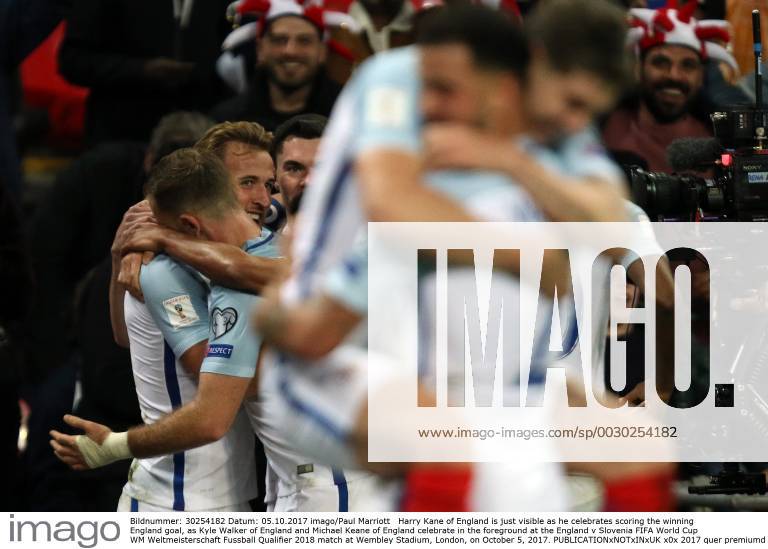 Harry Kane of England is just visible as he celebrates scoring the winning England goal, as Kyle Walker of England and Michael Keane of England celebrate in the foreground at the England v Slovenia FIFA World Cup WM Weltmeisterschaft Fussball Qualifier 2018 match at Wembley Stadium, London, on October 5, 2017.