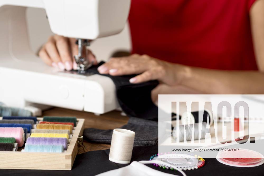 Woman sews Face mask with Thread