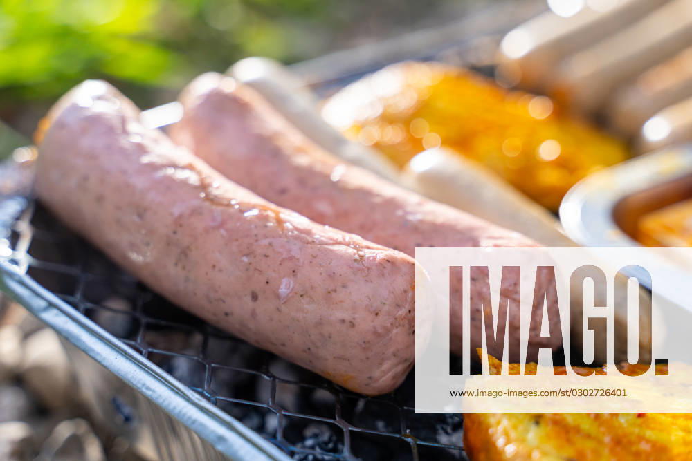 Bavaria, Germany - 2 September 2023: Vegetarian Grilling, Bratwurst Vegan and Vegetarian on a disposable grill. Meat and sausage substitutes