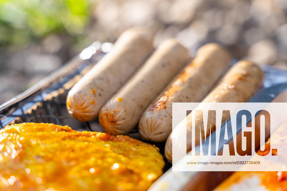 Bavaria, Germany - 2 September 2023: Vegetarian Grilling, Bratwurst Vegan and Vegetarian on a disposable grill. Meat and sausage substitutes