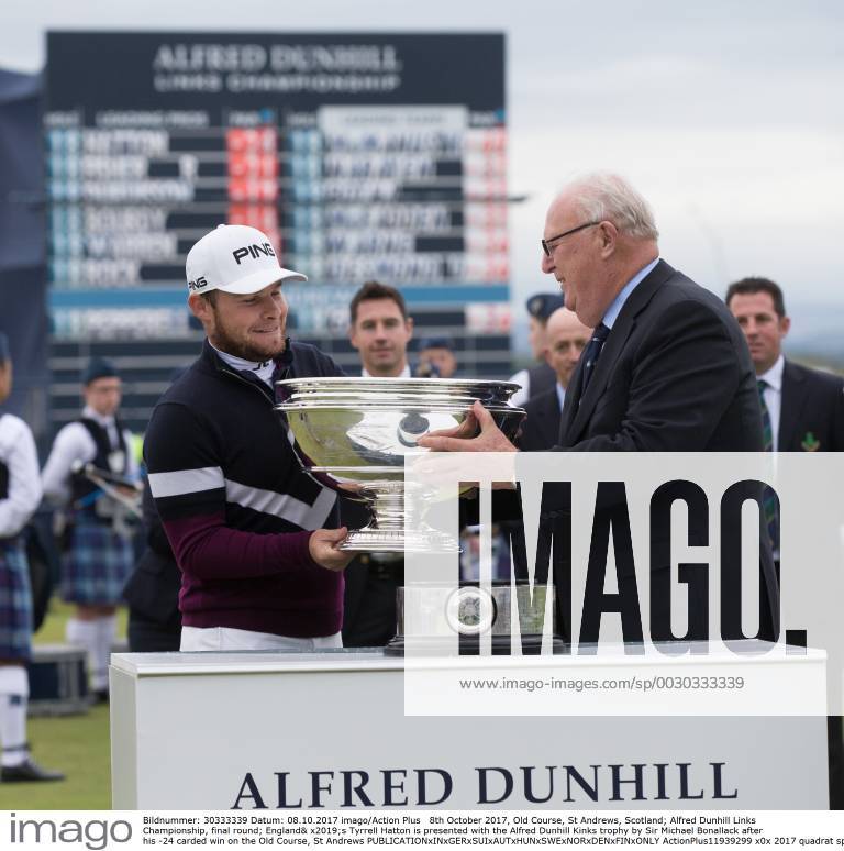 8th October 2017, Old Course, St Andrews, Scotland; Alfred Dunhill Links Championship, final round; England& x2019;s Tyrrell Hatton is presented with the Alfred Dunhill Kinks trophy by Sir Michael Bonallack after his -24 carded win on the Old Course, St Andrews ActionPlus11939299