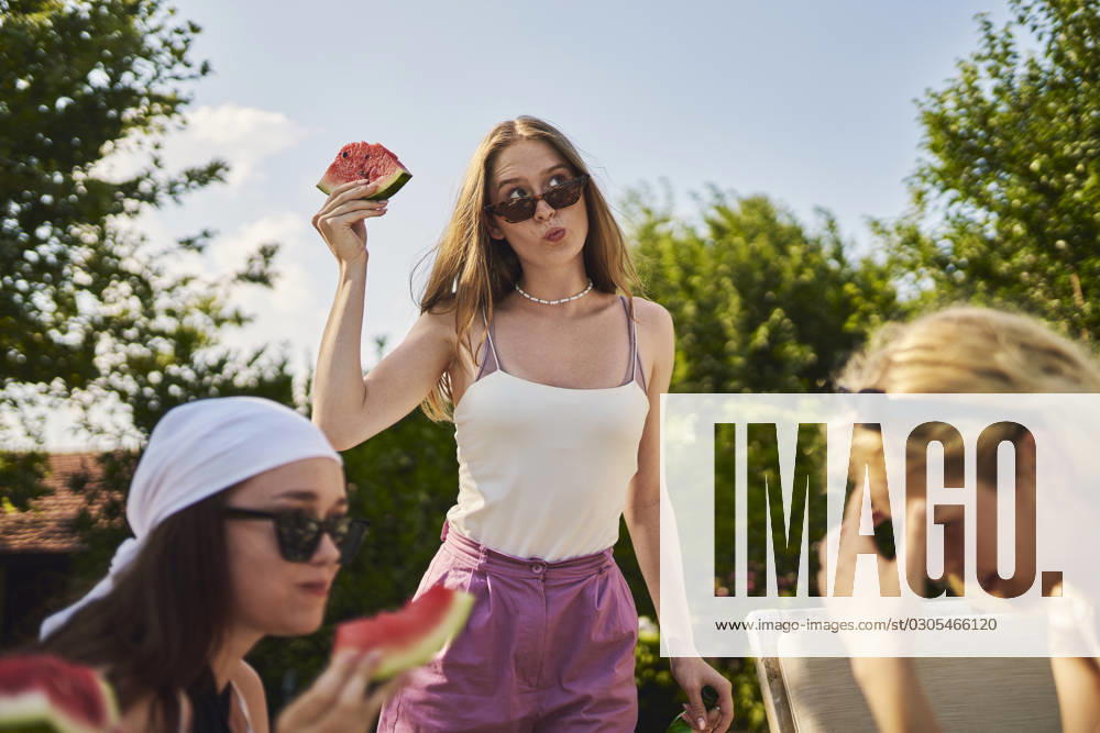 Woman holding slice of watermelon on sunny day model released, Symbolfoto property released, ANNF00412
