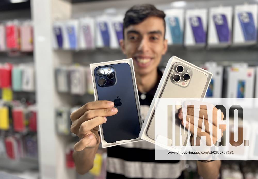 A smart phone seller displays an iPhone 15 Pro Max and iPhone 15 Pro, inside his shop in Gaza city, 25 September 2023. The first versions of the iPhone 15 phones produced by Apple reached the shops in the Gaza Strip today, Monday. The price of iPhone 15 Pro and iPhone 15 Pro Max in Gaza Strip ranging from $2,300 to $2,000. Gaza City Palestine - ZUMAq100 20230925_zaa_q100_060