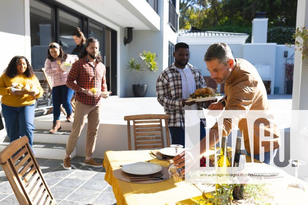 Happy diverse male and female friends serving thanksgiving celebration meal in sunny garden Happy diverse male and female friends serving thanksgiving celebration meal in sunny garden. Celebration, friendship, patriotism, american culture and tradition, unaltered., model released, , property released, Cape Town, South Africa, 07.09.2023, 4193319.jpg, people,happy,diverse,male and female,friend,serving,thanksgiving,celebration,meal,sunny,garden,friendship,patriotism,american culture,tradition,unaltered,holiday,patriotic,dinner,fun,nation,young,lunch,happiness,together,beautiful,spring,summer,party,food,traditional,season,christmas,cheerful,decoration,flag,male,female,american,culture Mid Adult,Man,Male,Black,Woman,Female,Multiracial,White,M