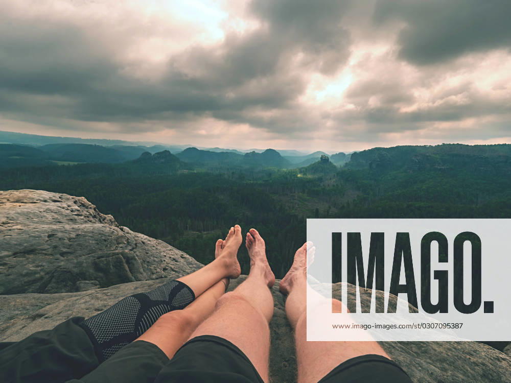 Tired hikers legs without shoes in mountains. Barefoot legs Tired hikers legs without shoes in mountains. Barefoot legs of heterosexual couple. Long forest valley in hilly landscae of nature park. ,model released, Symbolfoto