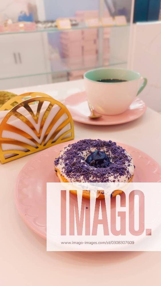 Donut with Ube Or purple Sweet potato flavor in a pretty Café with Pink pastel-coloured