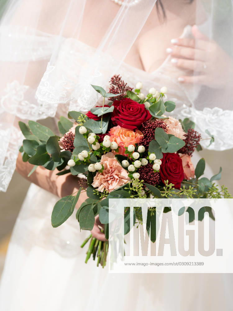A bride holds her bridal bouquet in her hand before the beginning of a free wedding ceremony Freudenstadt Baden Württemberg Germany
