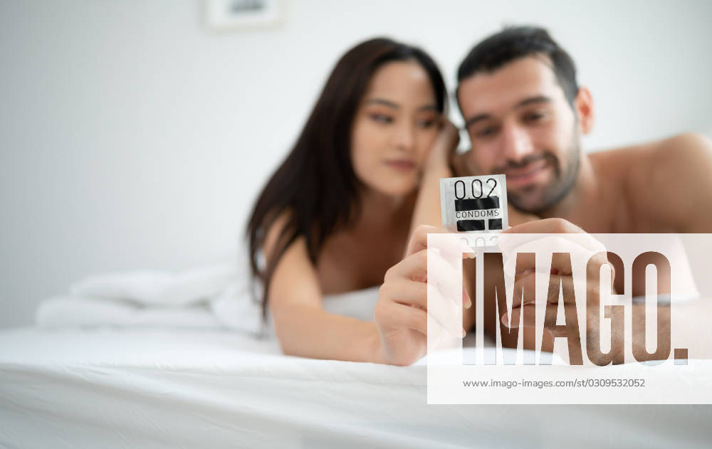 Gorgeous sexy couple enjoying sex in the house s bedroom, Safe sex concept, couples with condoms. Gorgeous sexy couple enjoying sex in the house s bedroom, Safe sex concept, couples with condoms. ,model released, Symbolfoto