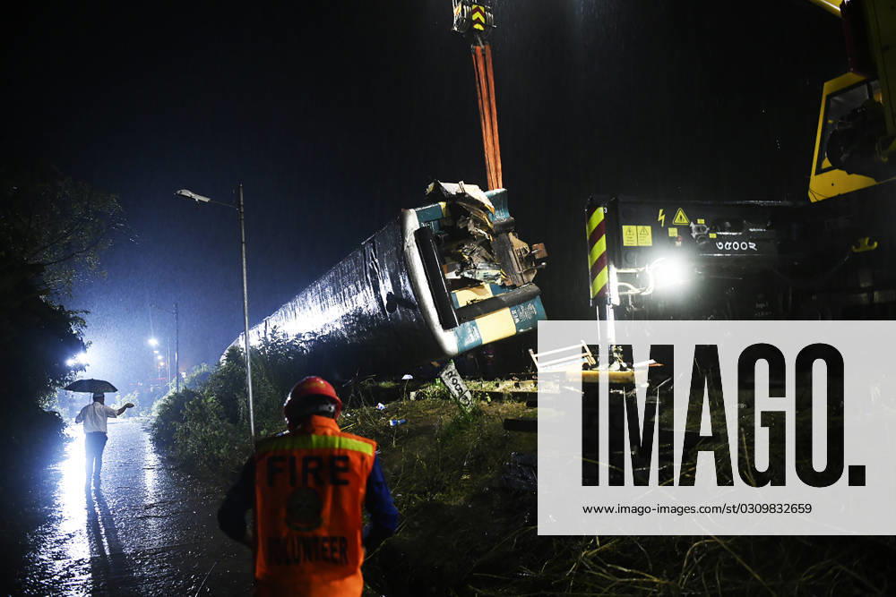 (231023) -- KISHOREGANJ (BANGLADESH), Oct. 23, 2023 -- Rescuers work to lift a carriage overturned in a train collision in Kishoreganj district, Bangladesh, on Oct. 23, 2023. At least 15 people were killed after two trains collided in Kishoreganj district, some 117 km northeast of Dhaka, on Monday, the district s Additional Superintendent of Police Md Mostak Sarker told Xinhua. BANGLADESH-KISHOREGANJ-TRAIN COLLISION Salim