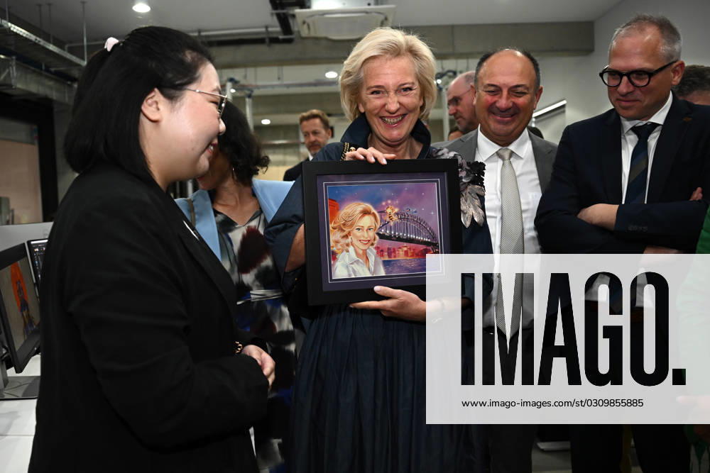 PRINCESS ASTRID OF BELGIUM ARTWORK, Princess Astrid of Belgium is gifted a portrait by illustrator Jihee Park (left) during a visit to Flying Bark?s Sydney studio in Sydney, Tuesday, October 24, 2023. ( NO ARCHIVING, , NO USE IN BOOKS WITHOUT CONSENT SYDNEY NEW SOUTH WALES AUSTRALIA