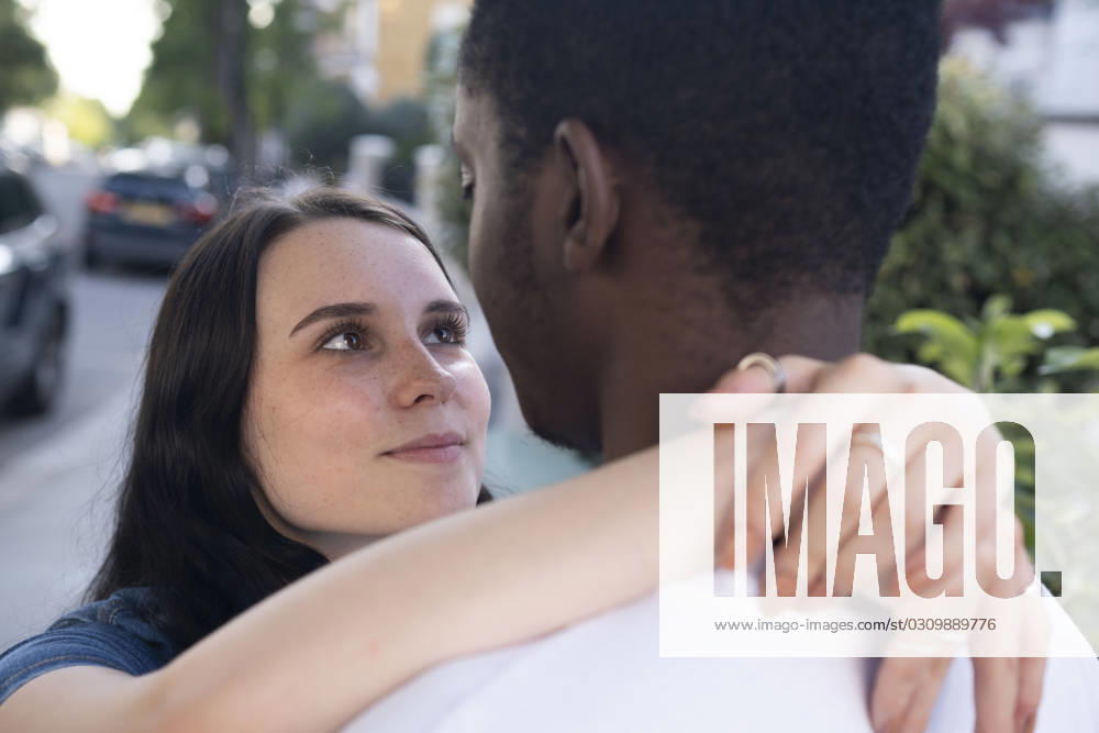 Smiling woman with arm around man at street model released, Symbolfoto, AMWF01775