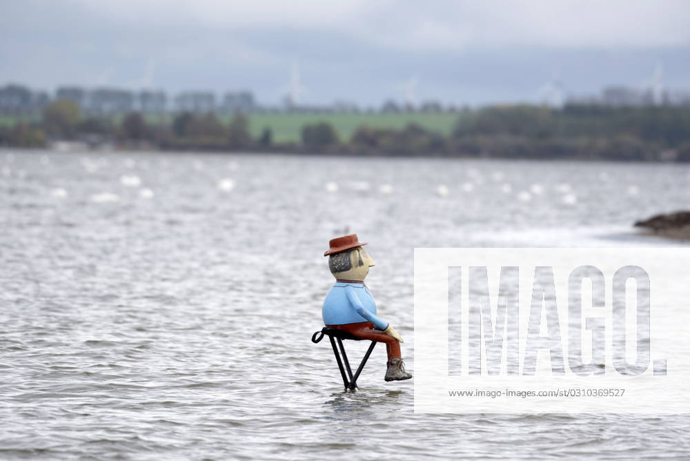 A man made of papier mâché sits on a stool in the water on the beach of Gollwitz on the island of Poel At the end of October, the low season begins on the Baltic Sea island of Poel in Mecklenburg Vorpommern Gollwitz