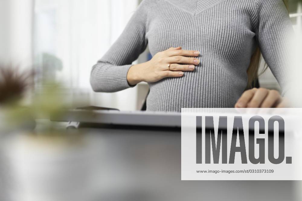 Pregnant women Businesswoman Office desk holds their Belly