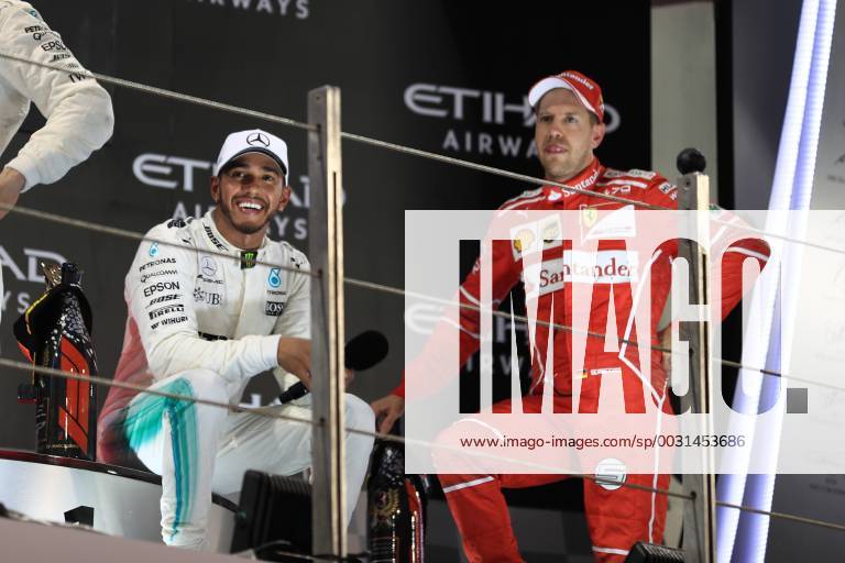 26th November 2017, Yas Marina Circuit, Abu Dhabi, UAE; Abu Dhabi Formula One Grand Prix, Sunday race day; Sebastian Vettel - Scuderia Ferrari speaks with Lewis Hamilton on the podium ActionPlus11956634
