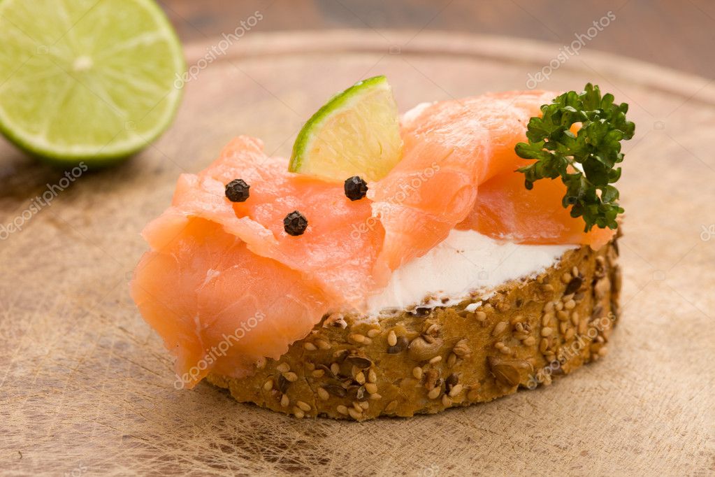 Photo of delicious crispy cereals bread with smoked salmon model released