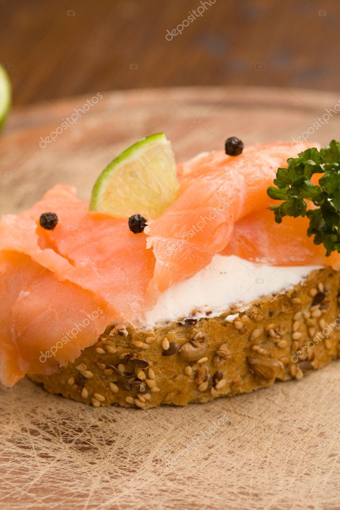 Photo of delicious crispy cereals bread with smoked salmon model released