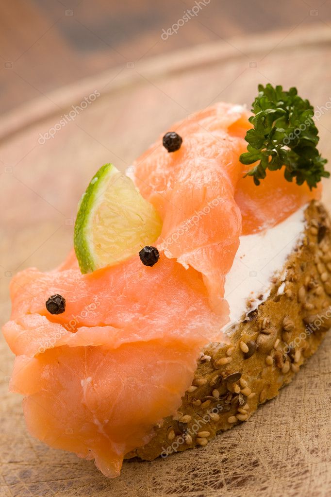 Photo of delicious crispy cereals bread with smoked salmon model released