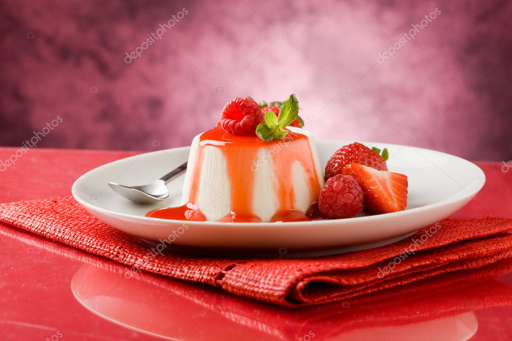 Photo of italian panna cotta dessert with strawberry sirup and mint leaf model released