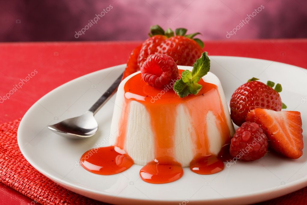 Photo of italian panna cotta dessert with strawberry sirup and mint leaf model released