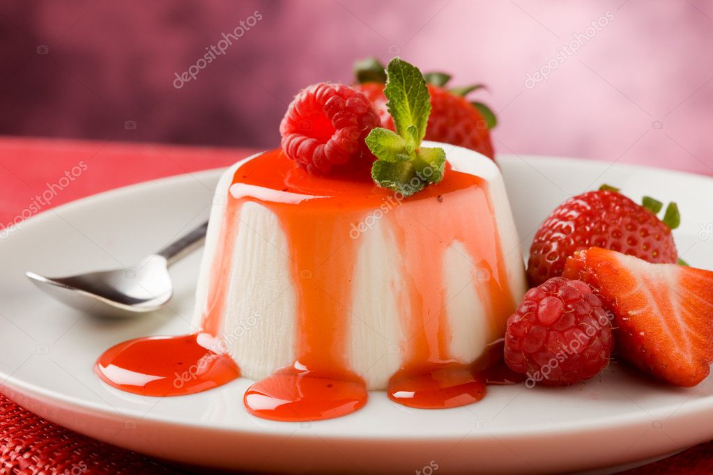 Photo of italian panna cotta dessert with strawberry sirup and mint leaf model released