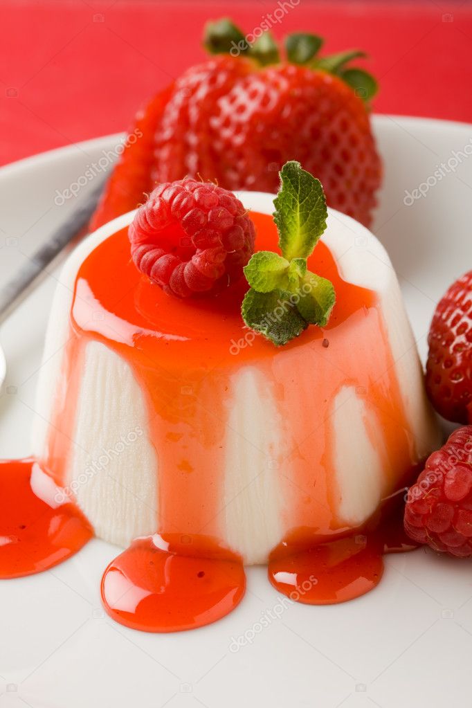 Photo of italian panna cotta dessert with strawberry sirup and mint leaf model released