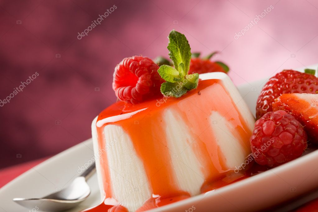 Photo of italian panna cotta dessert with strawberry sirup and mint leaf model released