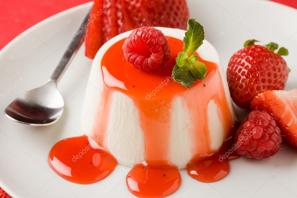 Photo of italian panna cotta dessert with strawberry sirup and mint leaf model released