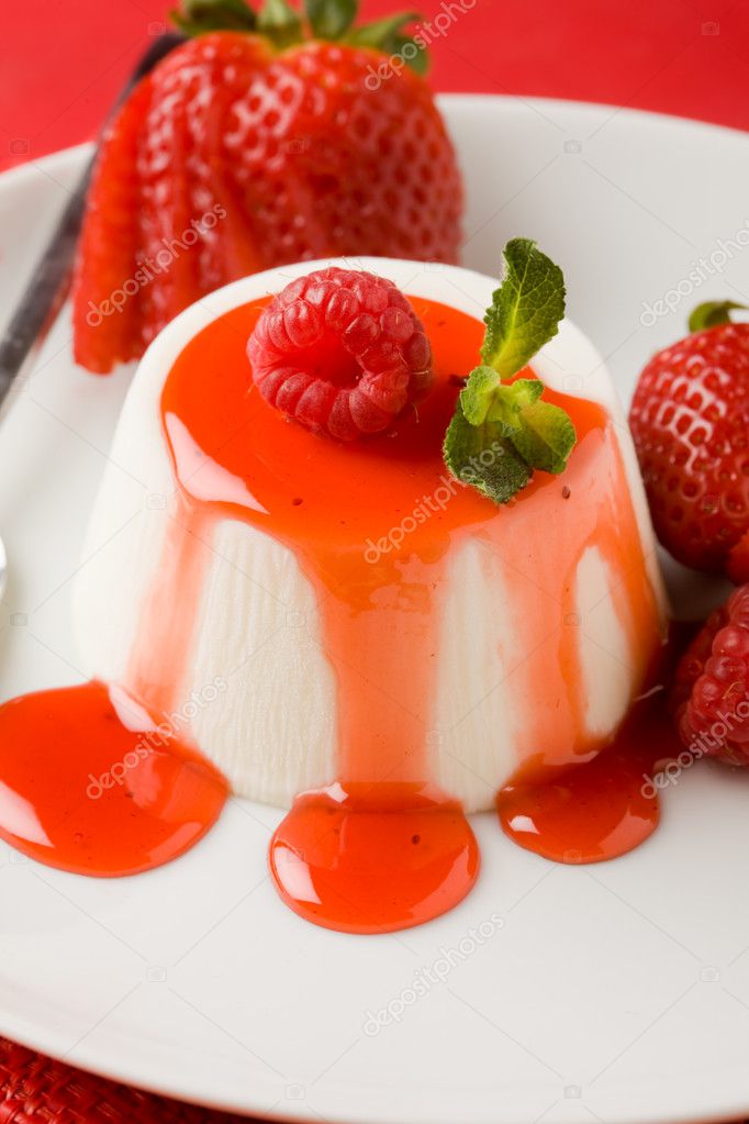 Photo of italian panna cotta dessert with strawberry sirup and mint leaf model released