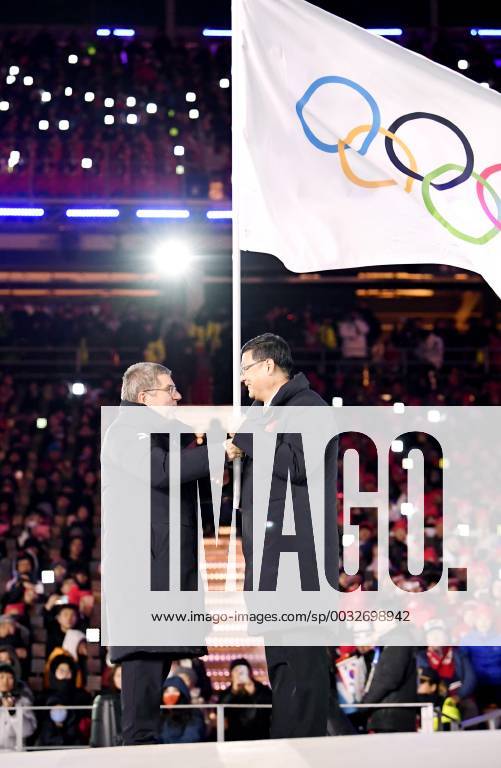 Pyeongchang Olympics International Olympic Committee President Thomas Bach (L) hands over the Olympic flag to Beijing Mayor Chen Jining during the closing ceremony of the Winter Olympics at the Pyeongchang Olympic Stadium in South Korea on Feb. 25, 2018.