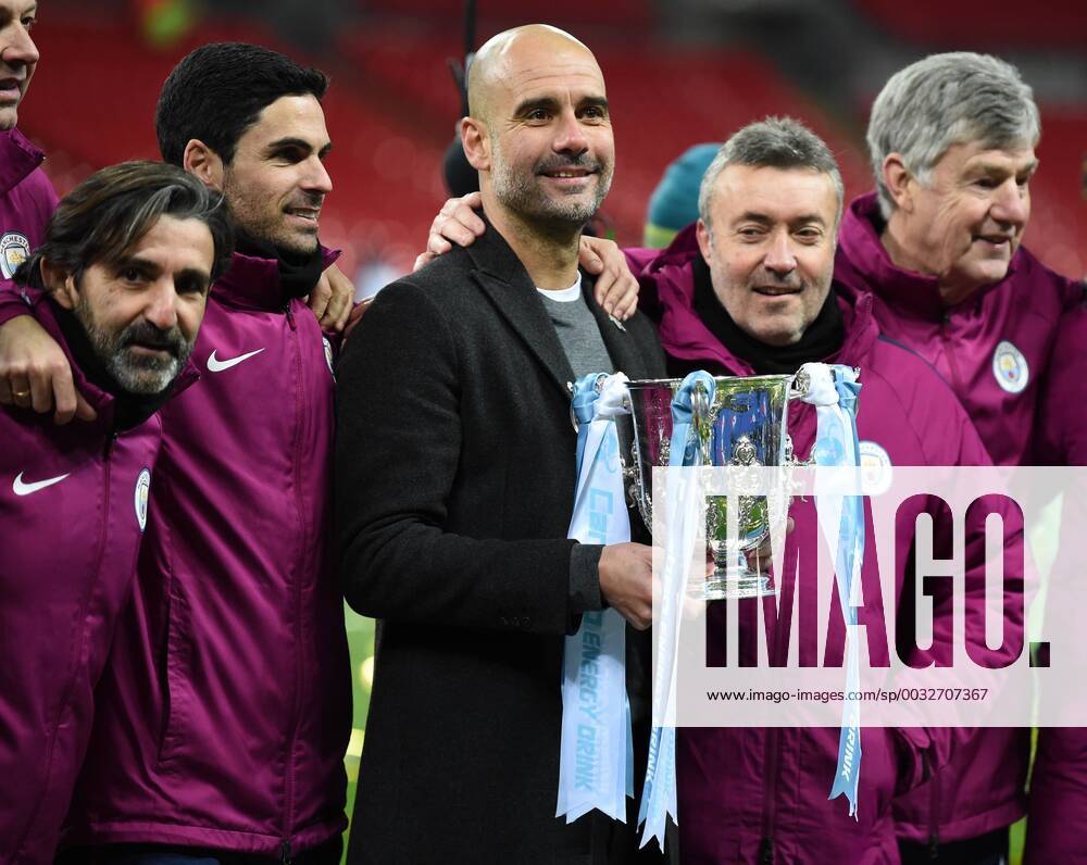 Arsenal v Manchester City Carabao Cup Final Josep Guardiola manager of Manchester City posses with the trophy and his coaching team at the end of the the Carabao Cup Final match at Wembley Stadium, London Content Not Available For UK Newspapers