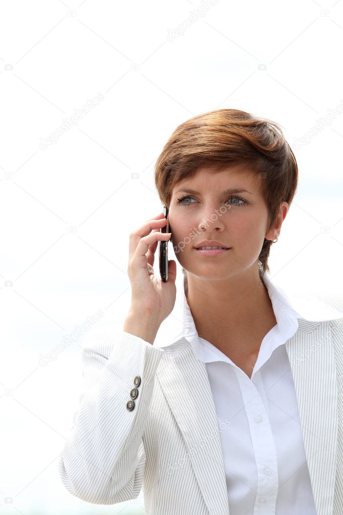 Closeup of a smiling businesswoman talking on the phone model released