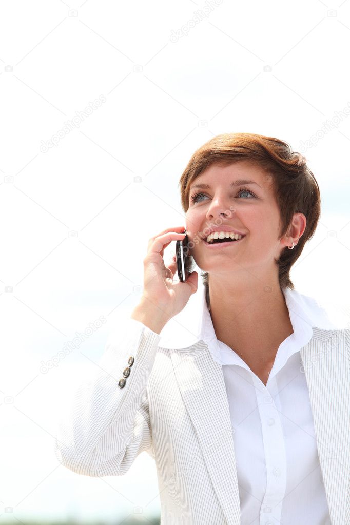Closeup of a smiling businesswoman talking on the phone model released