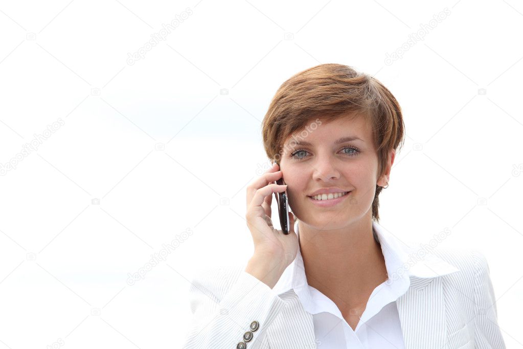 Closeup of a smiling businesswoman talking on the phone model released
