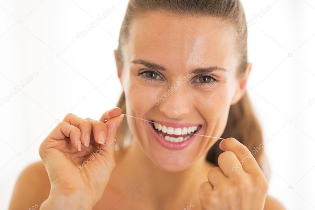 Portrait of young woman using dental floss model released