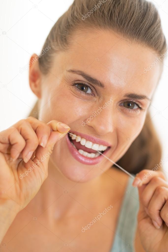 Portrait of young woman using dental floss model released