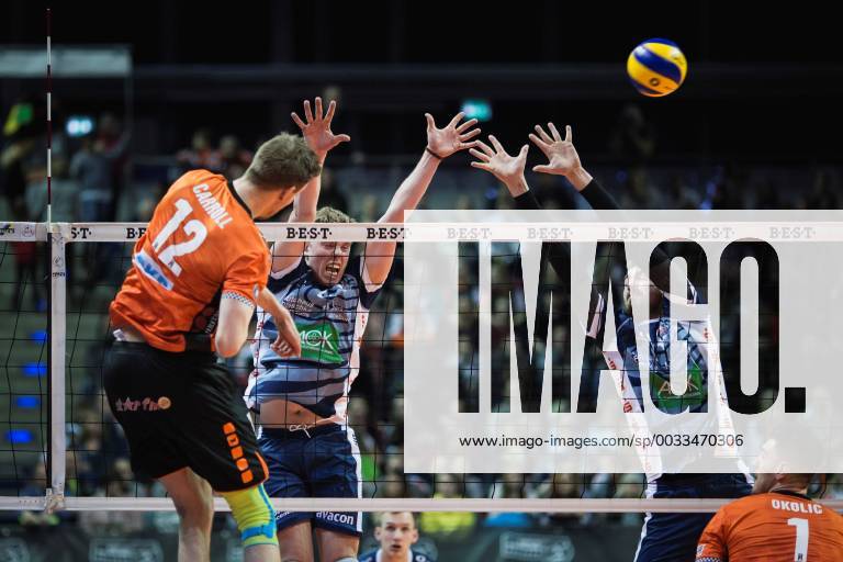 Berlin Germany 28 03 2018 Paul Carroll BR Volleys 12 against the block from Gijs van Solkema Lüneburg 2 and Michel Schlien Lüneburg 14 at Play Off Quarterfinals Game 1 of the Volleyball Bundesliga between Berlin Recycling Volleys and SVG Lüneburg