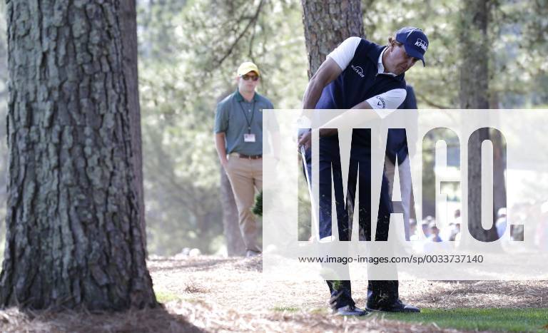 Phil Mickelson hits his second shot from out of the pine straw to the 1st hole in the 2nd round of the 2018 Masters Tournament at the Augusta National Golf Club in Augusta, Georgia, on April 6, 2018. AUG20180406107 JOHNxANGELILLO