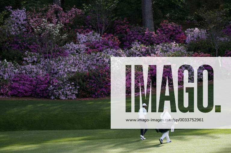 Tiger Woods and caddie Joe LaCava walk to the 13th green in the 2nd round of the 2018 Masters Tournament at the Augusta National Golf Club in Augusta, Georgia, on April 6, 2018. AUG20180406148 JOHNxANGELILLO