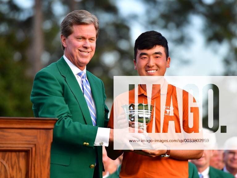 Augusta National Chairman Fred Ridley presents Doug Ghim with the low amateur trophy at the 2018 Masters Tournament at the Augusta National Golf Club in Augusta, Georgia, on April 8, 2018. AUG20180408328 KEVINxDIETSCH
