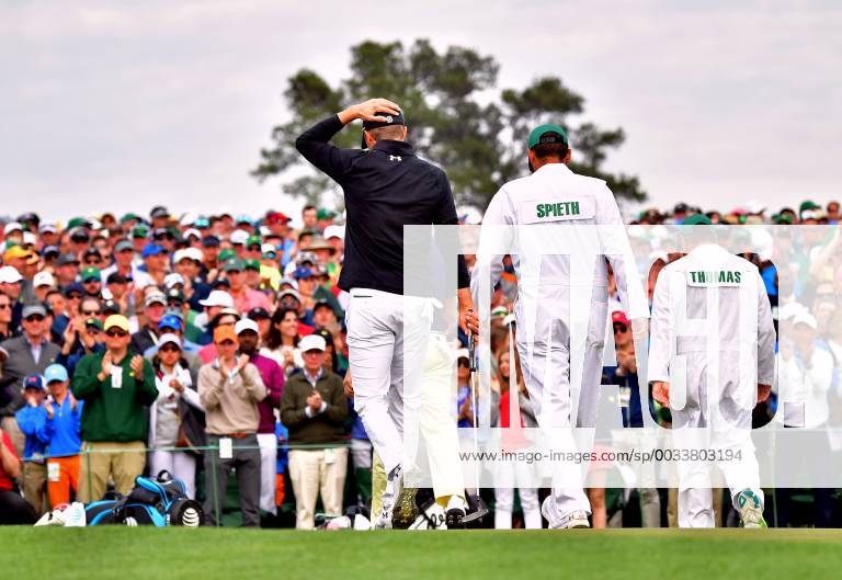 Jordan Spieth and his caddie Michael Greller walk off 18th green after finishing his final round during the 2018 Masters Tournament at the Augusta National Golf Club in Augusta, Georgia, on April 8, 2018. AUG20180408343 KEVINxDIETSCH