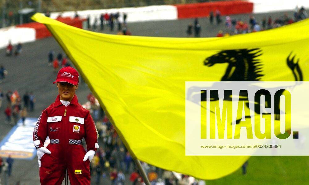 BRU270 - - FRANCORCHAMPS, BELGIUM : A huge Ferrari flag waves besides a model of German Michael Schumacher at the end of the Belgian F1 Grand Prix, 01 September 2002, on the race track of Spa - Francorchamps. German World Champion Michael Schumacher won ahead of his teammate Rubens Barrichello and Colombian Juan Pablo Montoya of Williams-BMW. BENOITxDOPPAGNE x1034683x