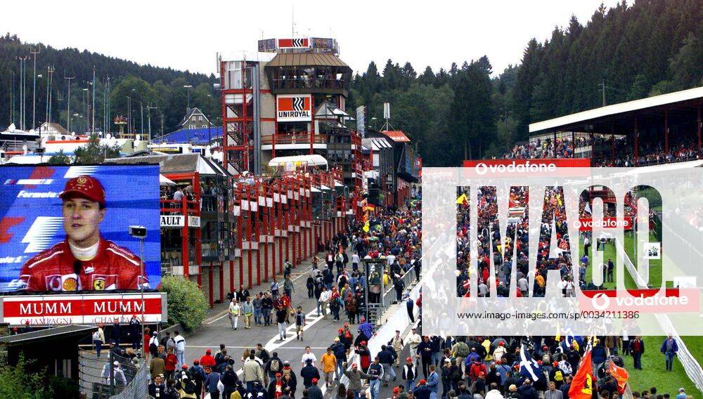 BRU48 - - FRANCORCHAMPS, BELGIUM : (FILE) A picture dated 01 September 2002 shows a giant screen displaying the image of Michael Schumacher at a news conference while the public walks on the track after the Belgian F1 Grand Prix on the race track of Spa - Francorchamps. Thursday 30 January 2003, Bernie Ecclestone announced the possibility for Spa Francorchamps Grand Prix to be part of a 18 races calendar in 2004. GUYxMOSSAY x1163563x