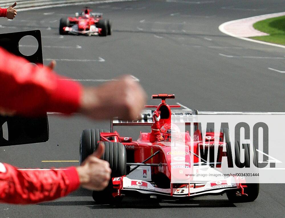BRU455 - - FRANCORCHAMPS, BELGIUM : German Michael Schumacher celebrates on the finish line of the Belgian Formula One Grand Prix, Sunday 29 August 2004, on the race track of Spa-Francorchamps. Finnish Kimi Raikkonen won the race and Michael Schumacher got World Champion for the 7th time. POOL-FRANCOISxLENOIR x2141461x