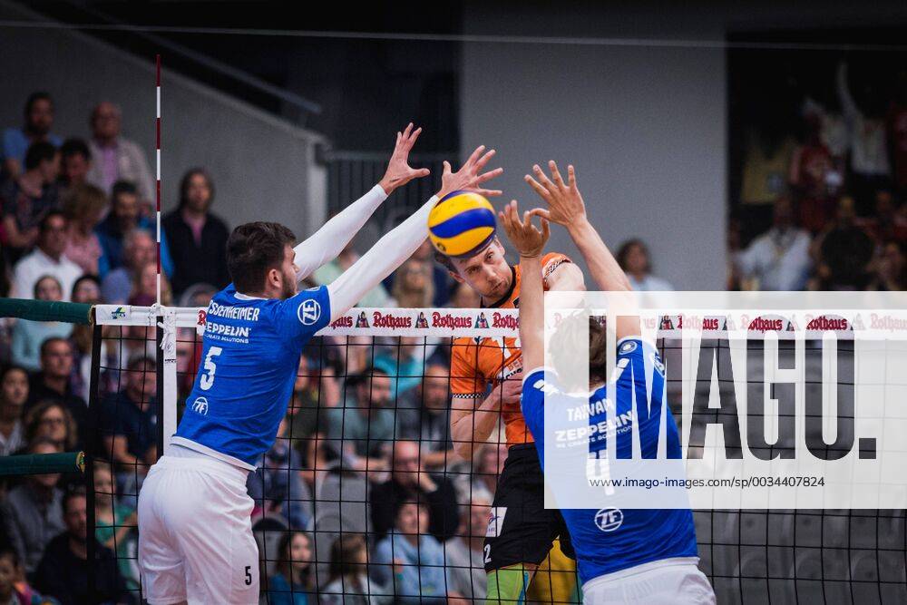 Friedrichshafen Germany 26 04 2018 Paul Carroll BR Volleys 12 against the block from David Sossenheimer Friedrichshafen 5 and Andreas Takvam Friedrichshafen 4 at the Playoff Final Game 1 of the Volleyball Bundesliga between VfB Friedrichshafen and the Berlin Recycling Volleys
