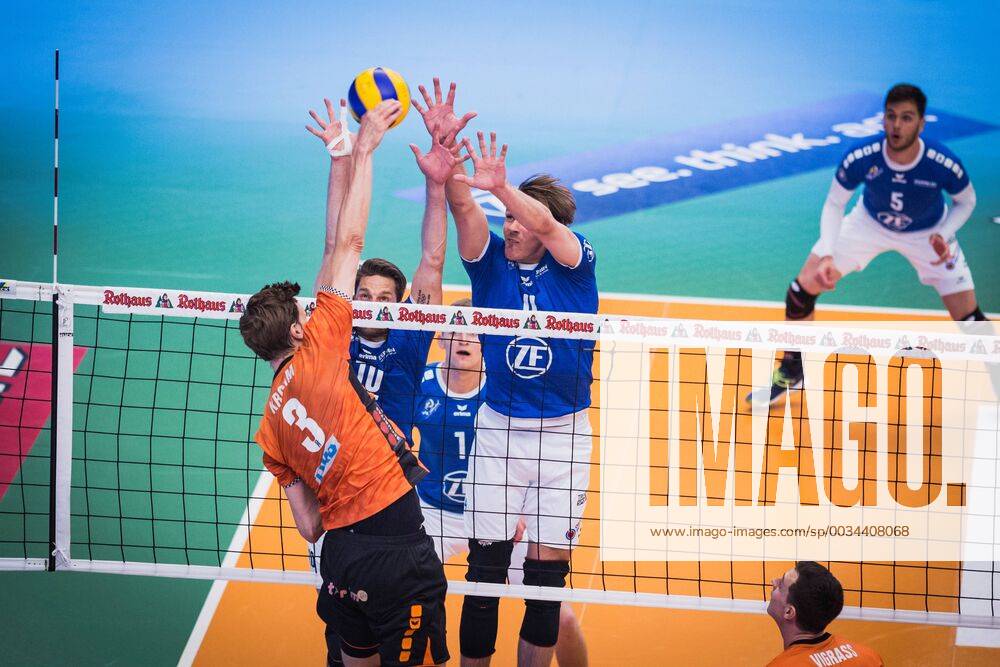 Friedrichshafen Germany 26 04 2018 Robert Kromm BR Volleys 3 against the block from Simon Tischer Friedrichshafen 10 and Andreas Takvam Friedrichshafen 4 at the Playoff Final Game 1 of the Volleyball Bundesliga between VfB Friedrichshafen and the Berlin Recycling Volleys