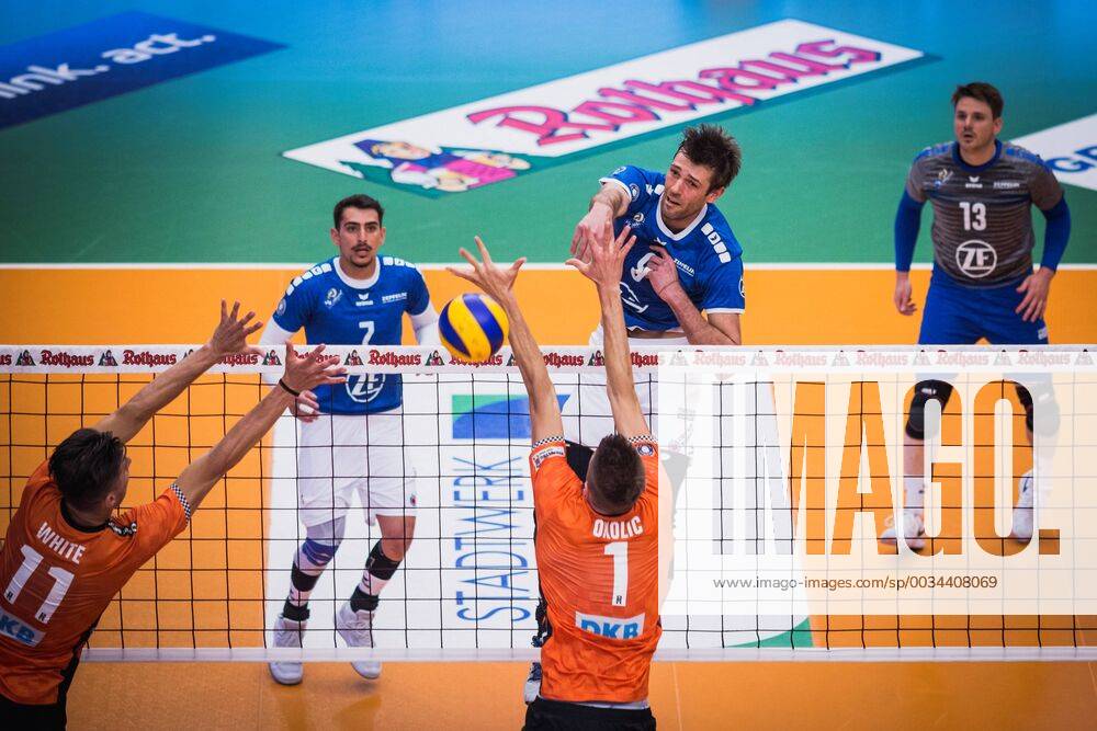 Friedrichshafen Germany 26 04 2018 Philipp Collin Friedrichshafen 9 against the block from Adam White BR Volleys 11 and Aleksandar Okolic BR Volleys 1 at Playoff Final Game 1 of the Volleyball Bundesliga between VfB Friedrichshafen and the Berlin Recycling Volleys