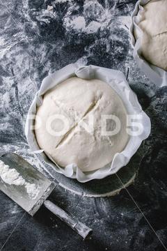 Process of making homemade bread. Fresh dough redy for baking on baked paper over black table with flour. Home bread baking. Photo series. Flat lay, space dough, bread, flour, bakery, pastry, kneading, homemade, making, cook, cooking, food, kitchen, table, baker, cuisine, ingredient, preparation, pizza, raw, prepare, healthy, bake, baking, fresh, background, nutrition, recipe, wheat, loaf, meal, home, traditional, organic, black, dark, preparing, paper, ready, top, view, overhead, above, flat, lay, space